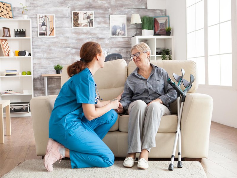 Professional carer assisting elderly client